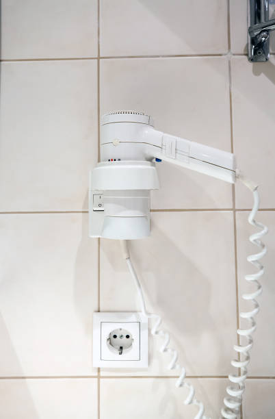 istock Hairdryer hanging on wall in hotel bathroom 1175185604