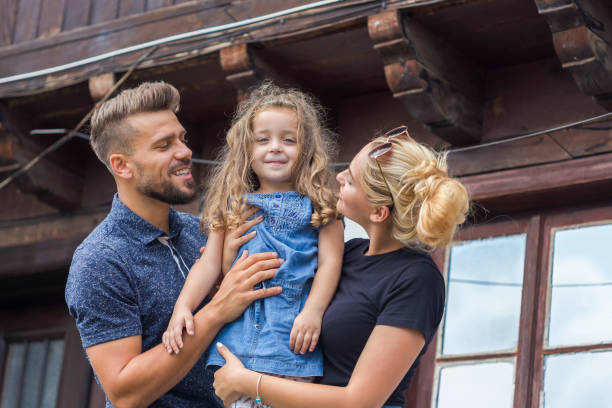 istock Happy family standing on the balcony 1175186953