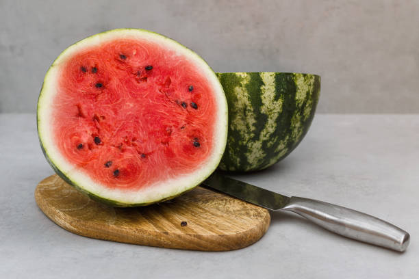 istock Fresh watermelon cut with knife. Watermelon cut half in two pieces. 1175187149