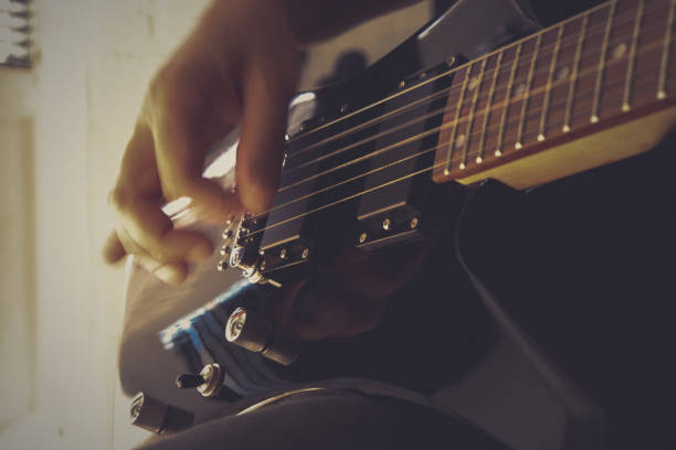 istock Musical lifestyle background. Playing the guitar. Guitarist's hand dynamic motion. Macro closeup. 1175192001