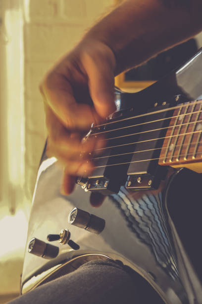 istock Playing the guitar. Guitarist's hand dynamic motion. Musical lifestyle background. Macro closeup. 1175192049
