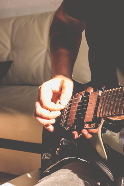 istock Guitarist's hand dynamic motion. Musical lifestyle background. Playing the guitar. Macro closeup. 1175192092