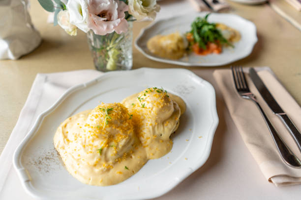 istock Egg Benedict on warm toast brioche. Two eggs delicious hollandaise sauce. Light morning Breakfast on table in restaurant. 1175195155