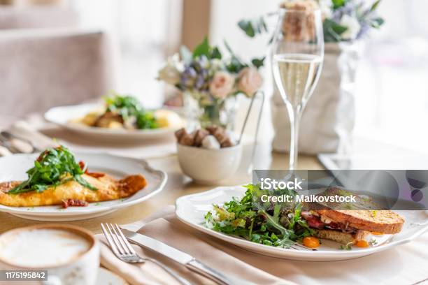 French Toast Brioche Sandwich With Pastrami And Sundried Tomatoes Light Morning Breakfast Fresh Warm Pastries On Table In Restaurant Stock Photo - Download Image Now