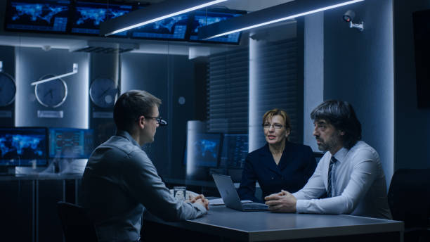 istock On a Job Interview Two Senior Managers Ask Young Candidate Questions. Secret Service Recruiting Talented Young Man. Serious People Working in Government Agency. 1175197056