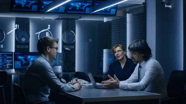 istock On a Job Interview Two Senior Managers Ask Young Candidate Questions. Secret Service Recruiting Talented Young Man. Serious People Working in Government Agency. 1175197095