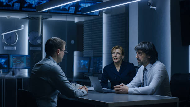 istock On a Job Interview Two Senior Managers Ask Young Candidate Questions. Secret Service Recruiting Talented Young Man. Serious People Working in Government Agency. 1175197107