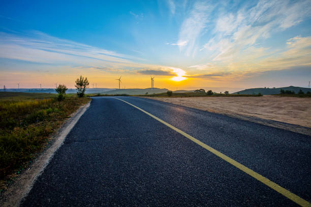 Asphalt road and wind turbines