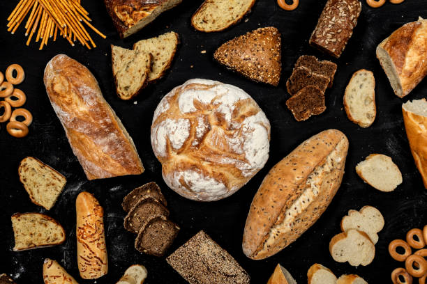 istock Assortment of different types of bread on a black background. Top view 1175199962
