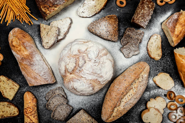 istock Assortment of different types of bread on a black background. Top view 1175199980