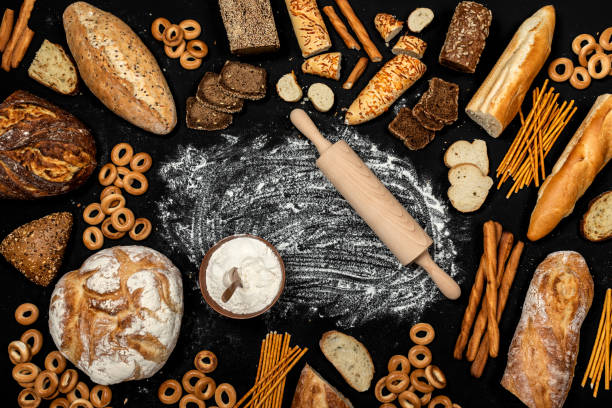 istock Assortment of different types of bread on a black background. Top view 1175200000