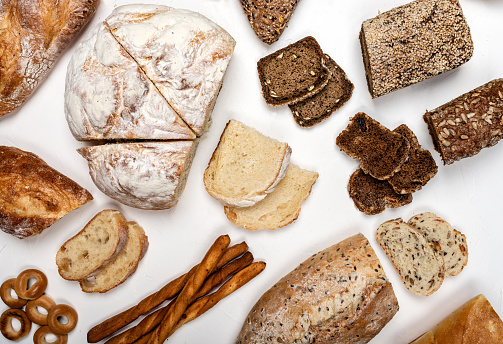 Different types of bread on a white background. Top view