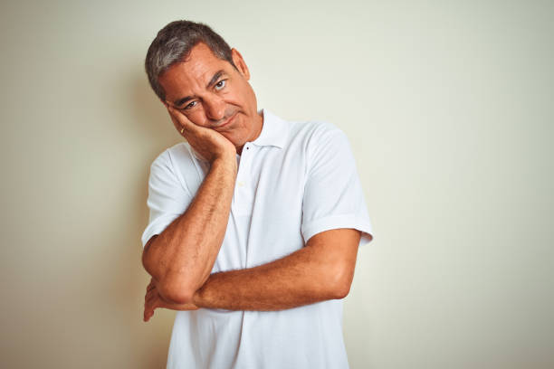 istock Handsome middle age man wearing polo standing over isolated white background thinking looking tired and bored with depression problems with crossed arms. 1175200403