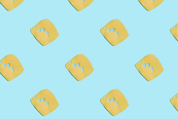 Cheese pattern on blue pastel background. Creative layout. Cheese pattern on blue pastel background. Creative layout. Top view. sliced chedder cheese stock pictures, royalty-free photos & images