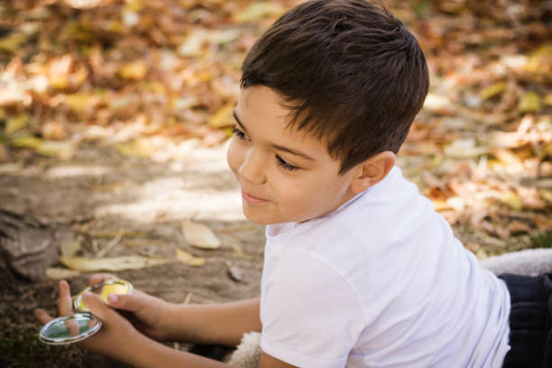 istock Cute smiling boy enjoying in autumn day in nature. 1175201740