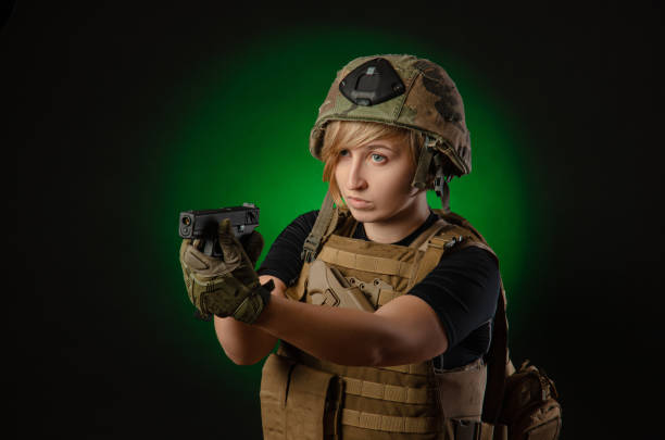 istock girl in uniform aims with a gun 1175204010