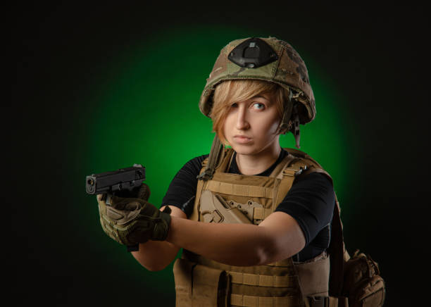 istock girl in uniform aims with a gun 1175204028