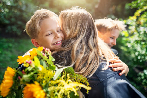 istock Little boys with flowers hugging their mother. 1175204245
