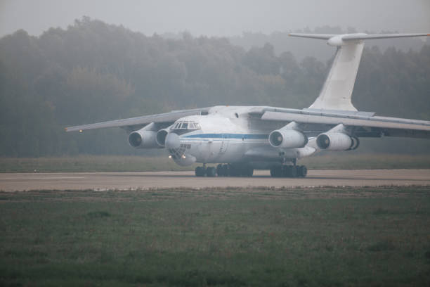 Heavy cargo airplane on the runway at fog