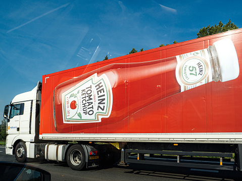 Amsterdam, Netherlands - Aug 22, 2019: Side view of large cargo truck with Heinz Tomato Ketchup bottle advertising the famous food product