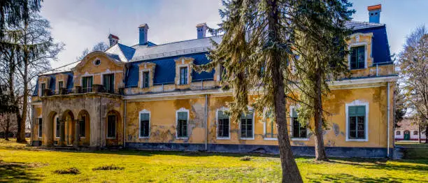 Somogysard Hungary Mar 23, 2019: The exteriors of - once so elegant - Somssich Country / Hunting chateau now in ruins,  from the XVIII century in a spring setting.