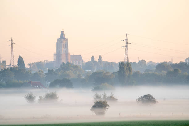 landscape on an early beautiful morning with some misty houses among the houses