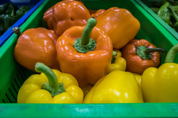 Whole bell orange pepper on wooden table