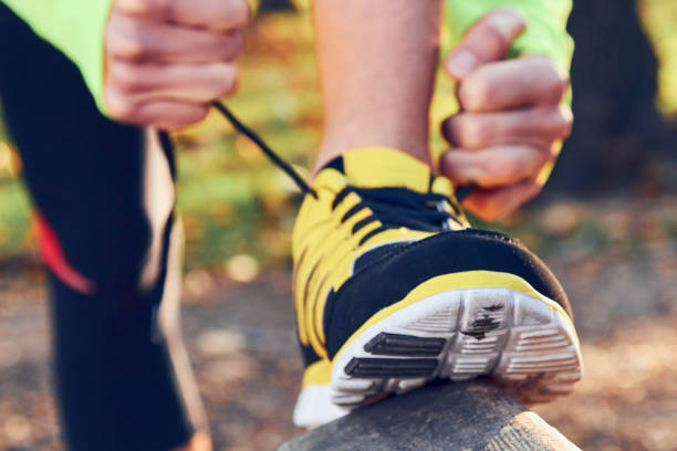 istock Preparing for jogging in autumn colored park. 1175210017