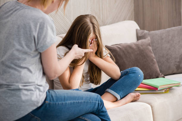 istock Mother scolds school crying daughter for homework 1175210110