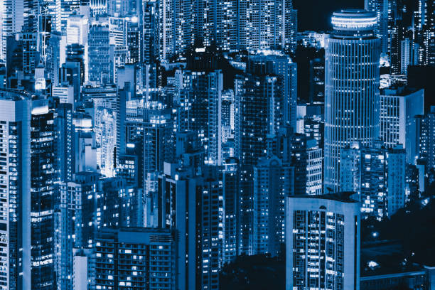 istock Pattern of office buildings windows illuminated at night. Lighting with Glass architecture facade design with reflection in urban city, Downtown Hong Kong City in financial district. 1175210973