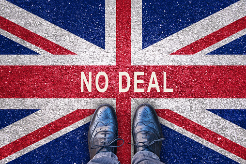 Brexit concept, no deal on a flag of the United Kingdom on asphalt road with legs