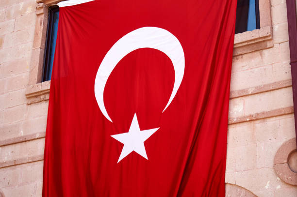 istock Turkish Flag. Waving in window over wall 1175213350