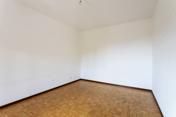 istock Empty room with all white walls and parquet floor 1175213553