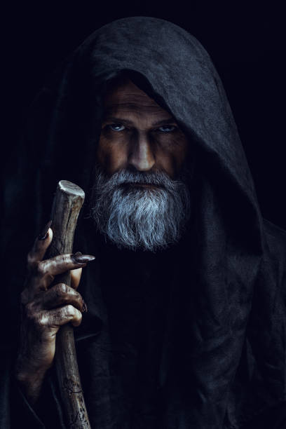 Mysterious hooded man Portrait of scary old man. Halloween theme. merlin the wizard stock pictures, royalty-free photos & images