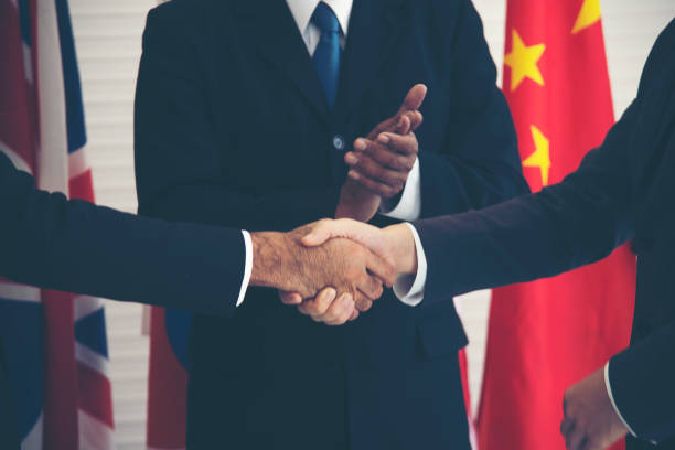 istock Businessman Applauding While Colleagues Shaking Hands In Office 1175215385