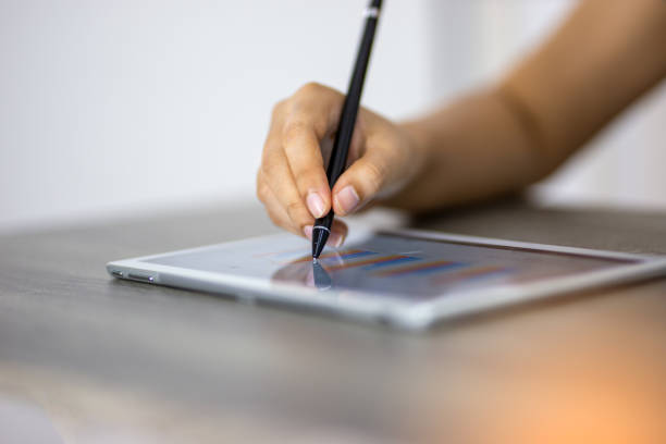 istock Cropped Hand Of Business Person Using Digital Tablet On Table 1175218085