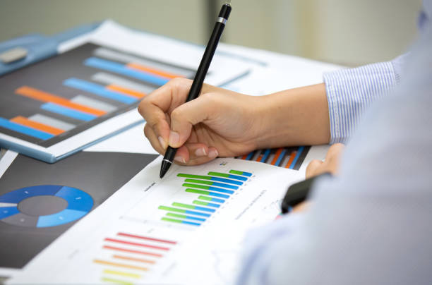 istock Midsection Of Businessman Working Over Graph On Table 1175219520