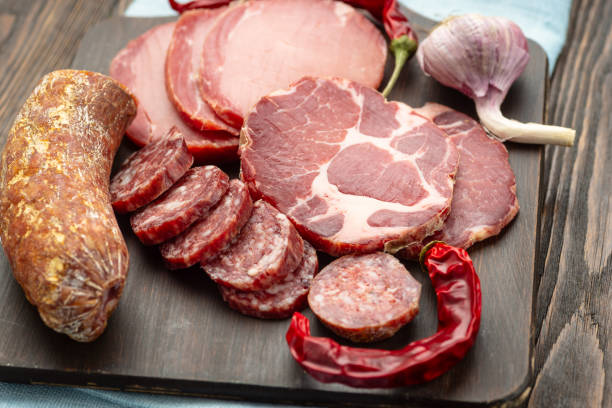 istock Antipasto platter cold meat with slices ham, beef jerky, salamon wooden board over rustic background 1175221649