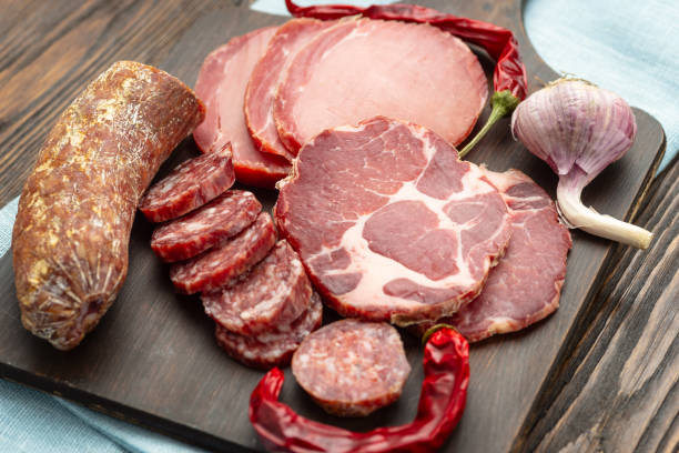 istock Antipasto platter cold meat with slices ham, beef jerky, salamon wooden board over rustic background 1175221661