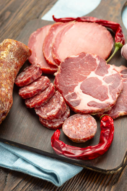 istock Antipasto platter cold meat with slices ham, beef jerky, salamon wooden board over rustic background 1175221896