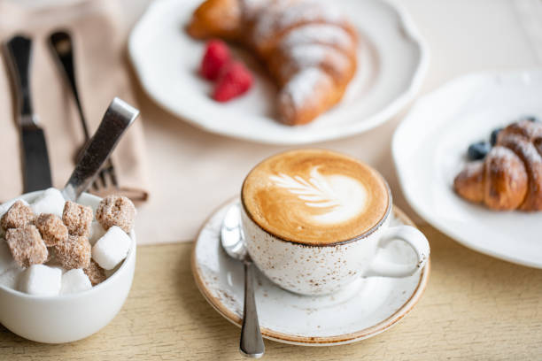istock Coffee cappuccino with two croissant on white plate in restaurant. Light morning Breakfast, fresh warm pastries and raspberries 1175226474