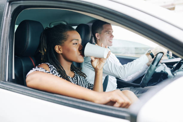 istock Woman drinking coffee in car 1175229086