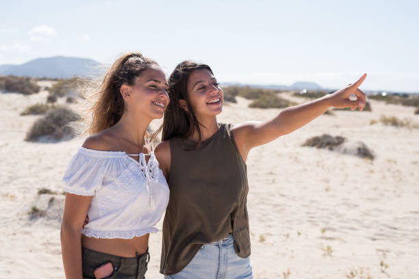 istock Two girls having fun at the beach 1175229755