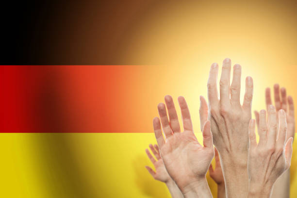 istock People raising hands and flag Germany on background. Patriotic c 1175234281