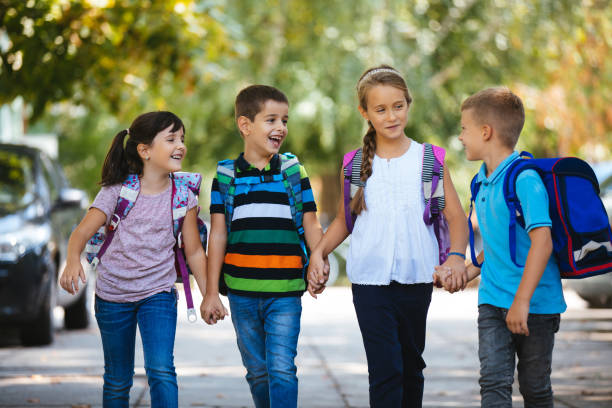 istock School children holding hands and going to school together 1175235110