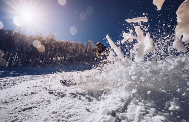 istock Young woman splashing snow while skiing on a mountain. 1175235138