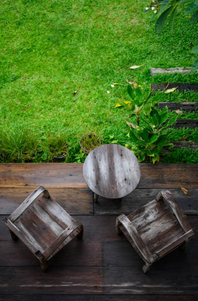 Top view of wooden table on balcony in the garden. stock photo