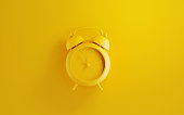 Yellow Alarm Clock on Yellow Background