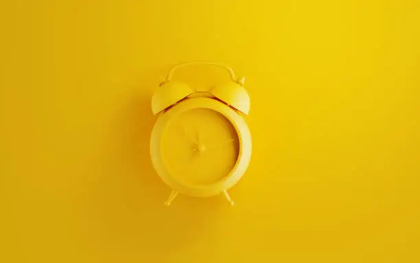 Photo of Yellow Alarm Clock on Yellow Background