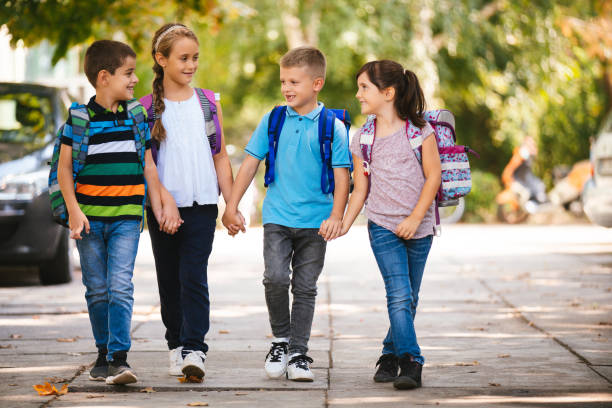 istock School children holding hands and going to school together 1175238385
